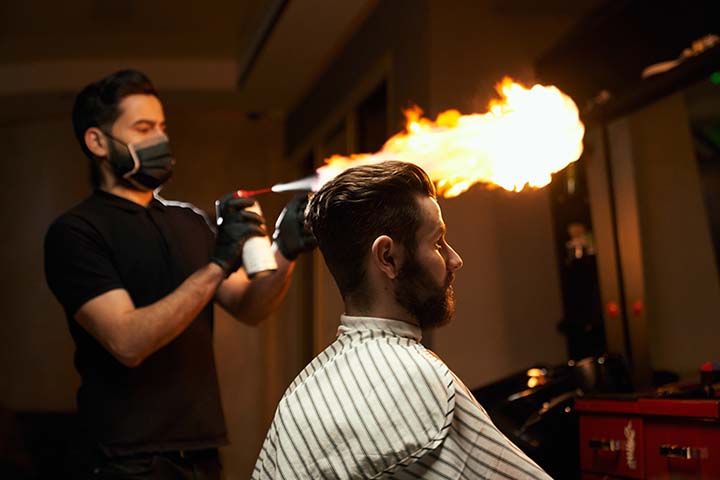 bearded barber wearing mask with bearded customer