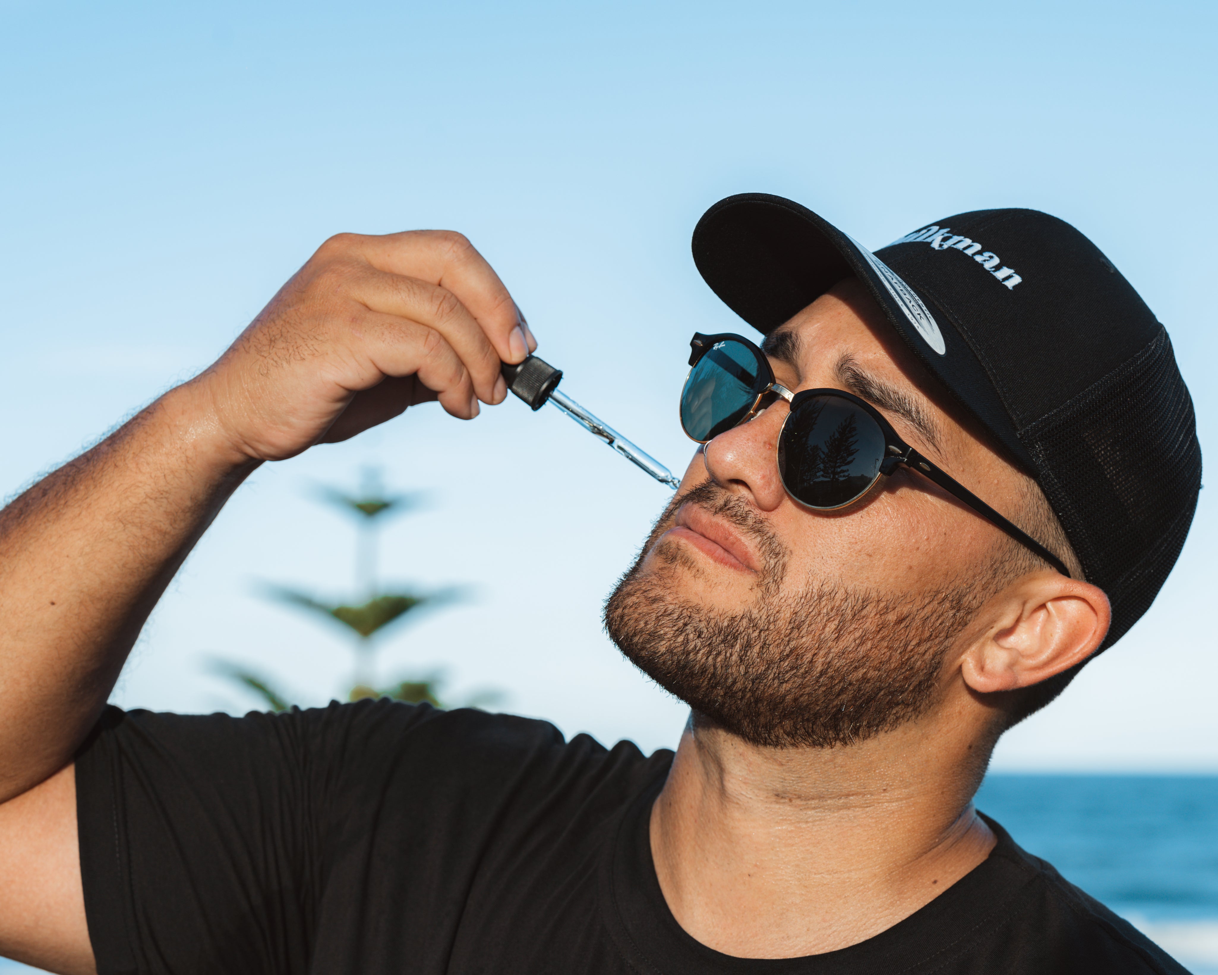 short bearded man applies beard oil