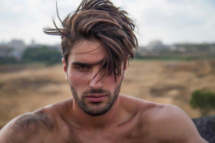 Guy with wind swept hair & stubble beard